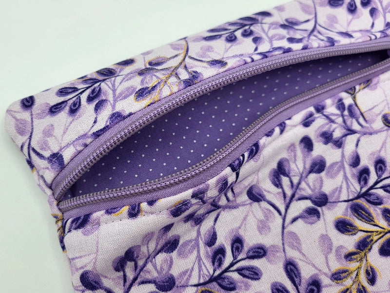 Floral-patterned pouch with a zipper on a light background
