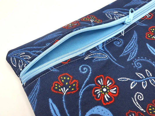 Floral-patterned pouch with a blue zipper on a white background
