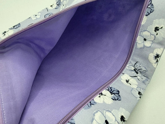 Purple fabric inside a floral-patterned bag