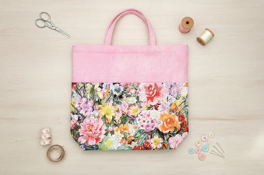 Floral tote bag with pink top section on a white background