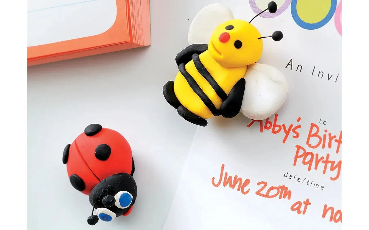 Two colorful insect-shaped decorations on a birthday party invitation.