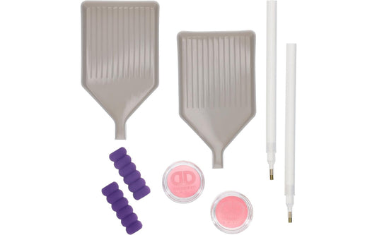 Set of makeup tools including two spatulas, two small round containers with pink and purple contents, and two thin applicators on a white background.