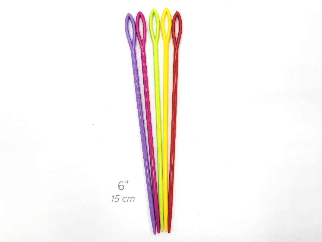 Four colorful knitting needles on a white background with a measurement label.
