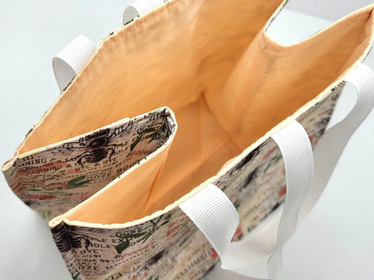 Close-up of a fabric bag with a patterned exterior and white interior.
