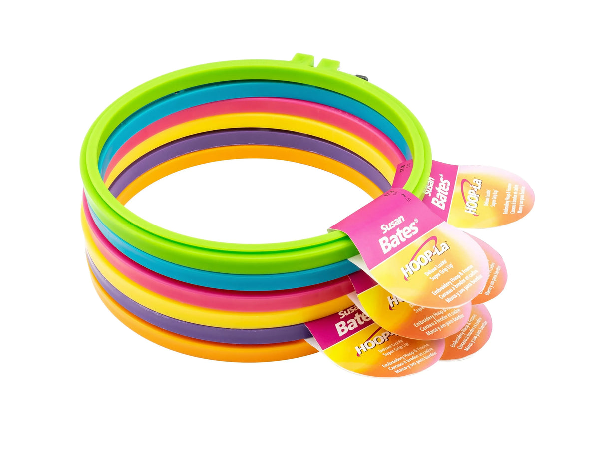 Set of colorful embroidery hoops with 'Hoop la' labels on a white background