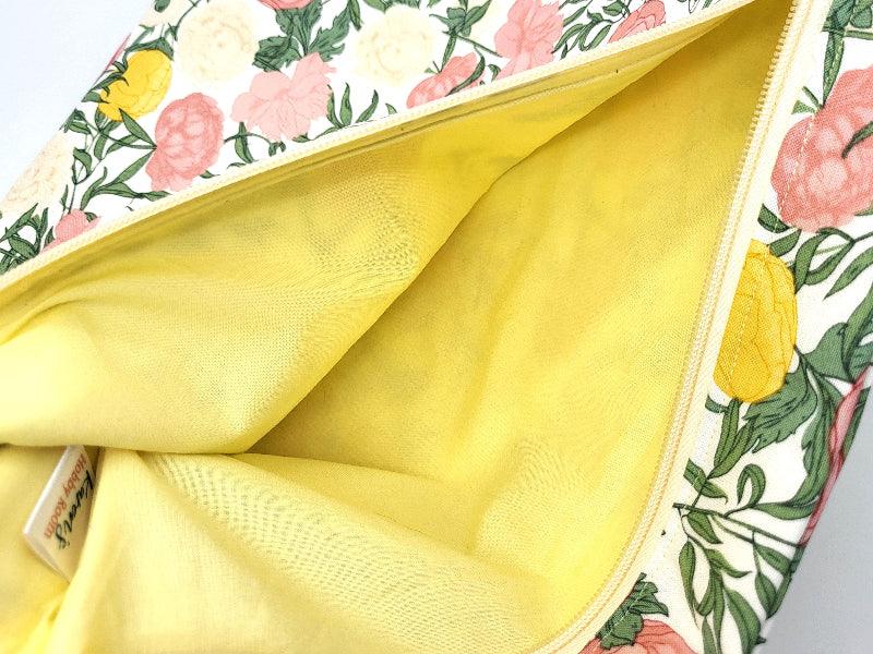 Close-up of a floral-patterned bag with yellow interior