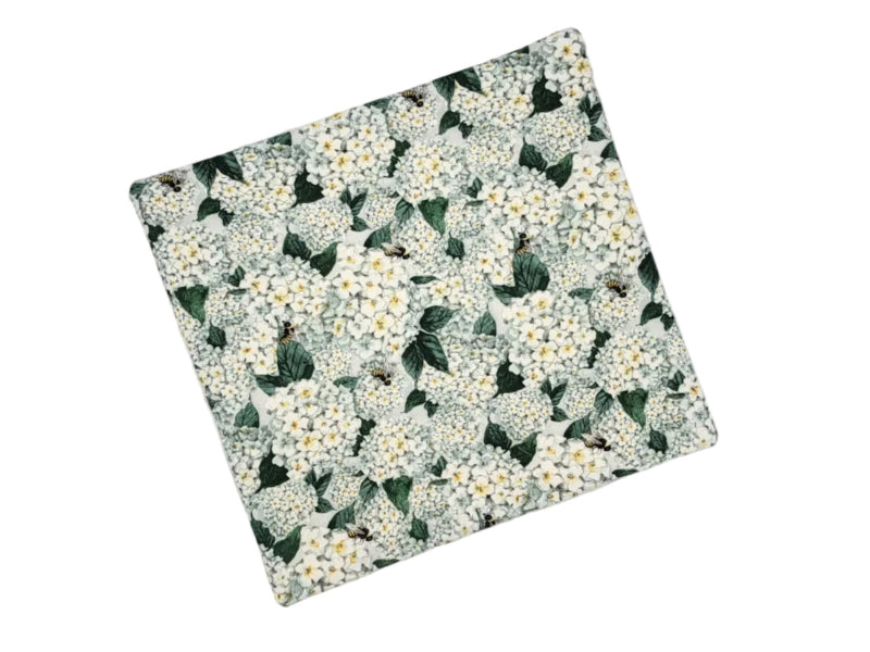 White floral cross-stitch bag on a with hydrangea leaves and bees