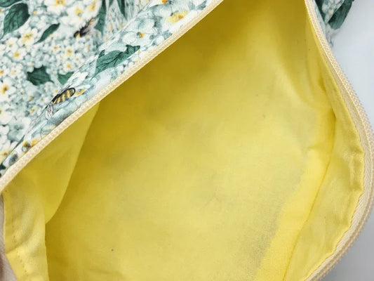 Close-up of a yellow fabric with floral patterned fabric partially visible