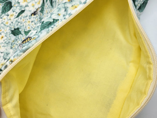 Close-up of a yellow fabric with floral patterned fabric partially visible