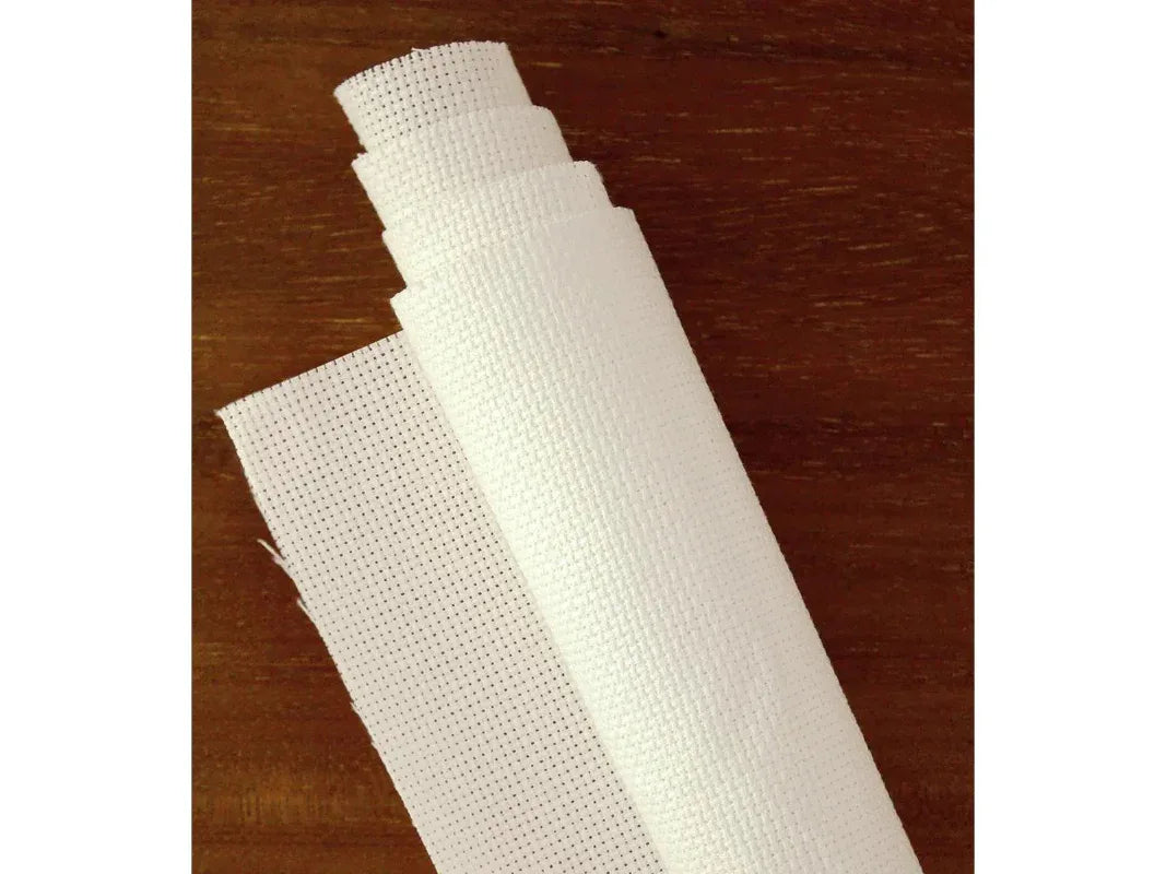Roll of white fabric on a wooden surface