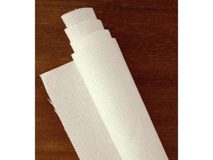 Roll of white fabric on a wooden surface