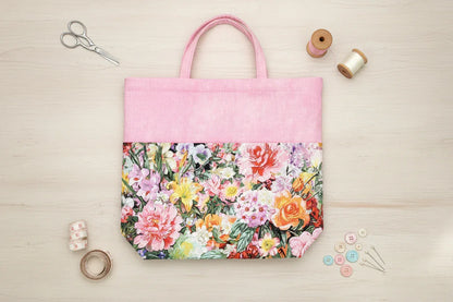Floral tote bag with pink top section on a white background