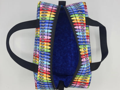 Interior view of crayon print duffle bag showing open zipper and spacious main compartment