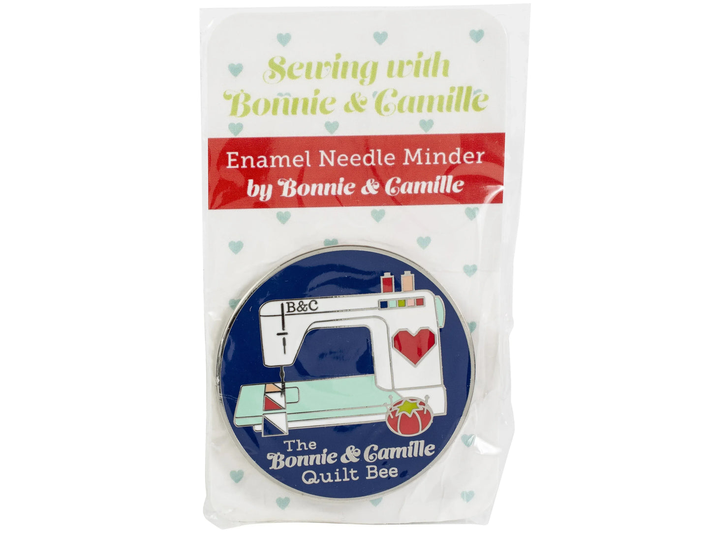 Enamel needle minder with Bonnie & Camille branding on a white background