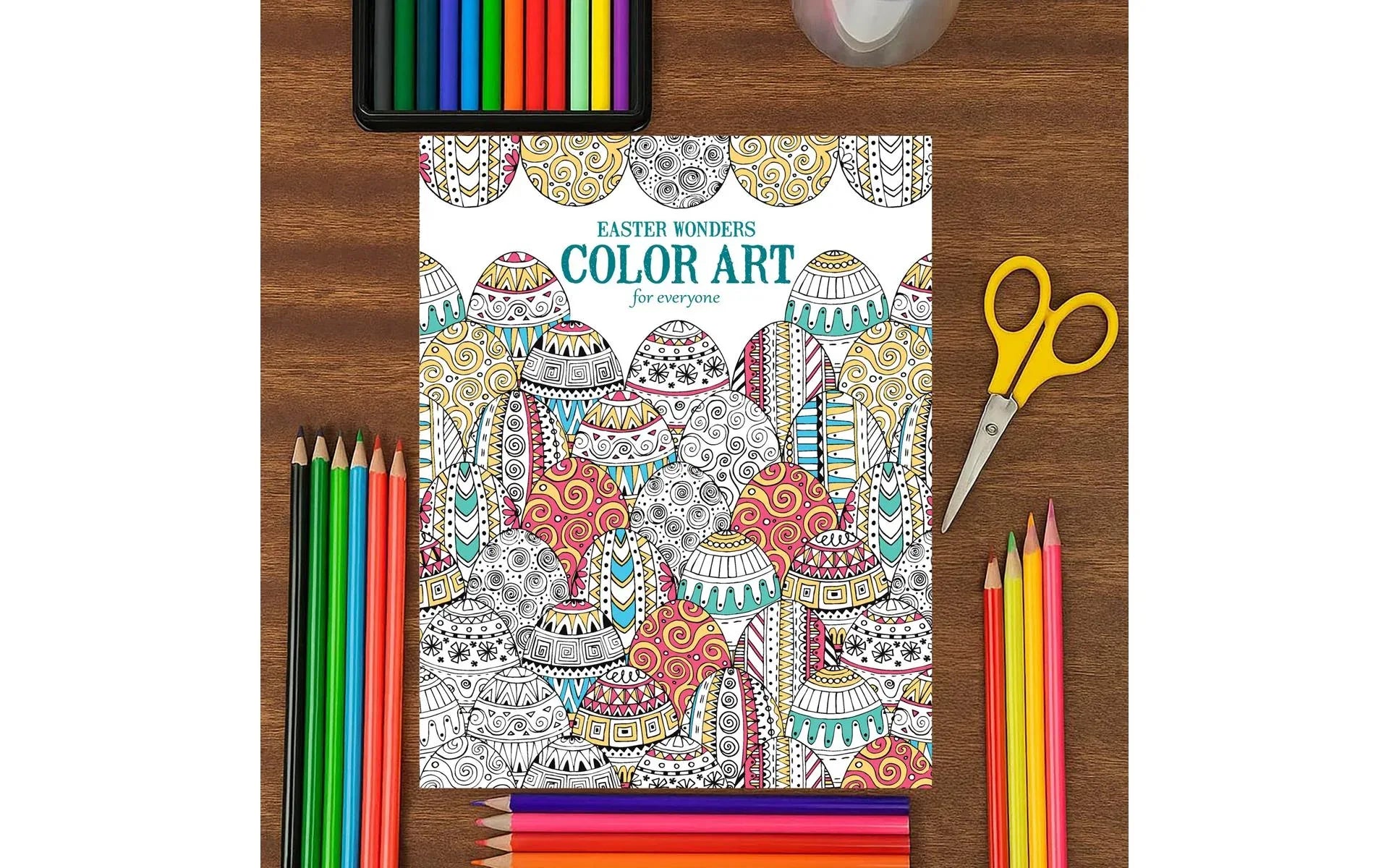 Coloring book with Easter designs on a wooden table with art supplies.