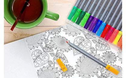 Coloring book with intricate designs, colored pencils, and a cup of tea on a wooden surface.