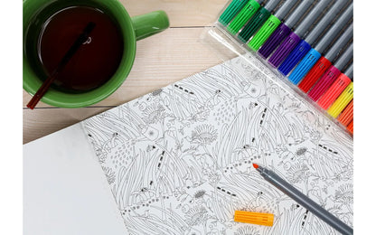 Coloring book with a cup of tea and coloring pencils on a wooden table