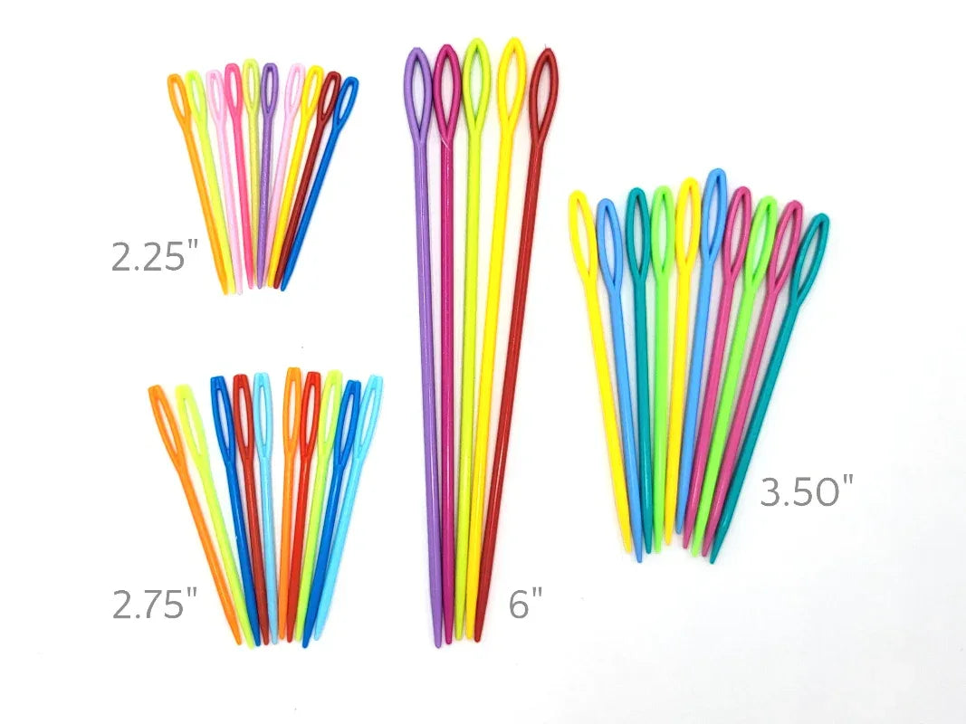 Colorful darning needles of different lengths on a white background