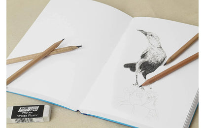 Artistic drawing of a bird in a sketchbook with pencils and an eraser.