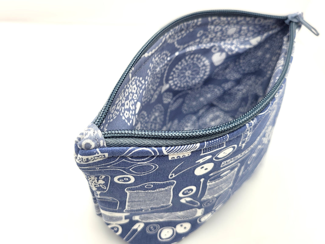 Blue pouch with white patterns on a white background