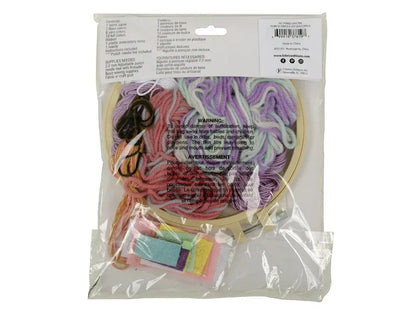 Packaged craft kit with yarn and embroidery hoop on a white background