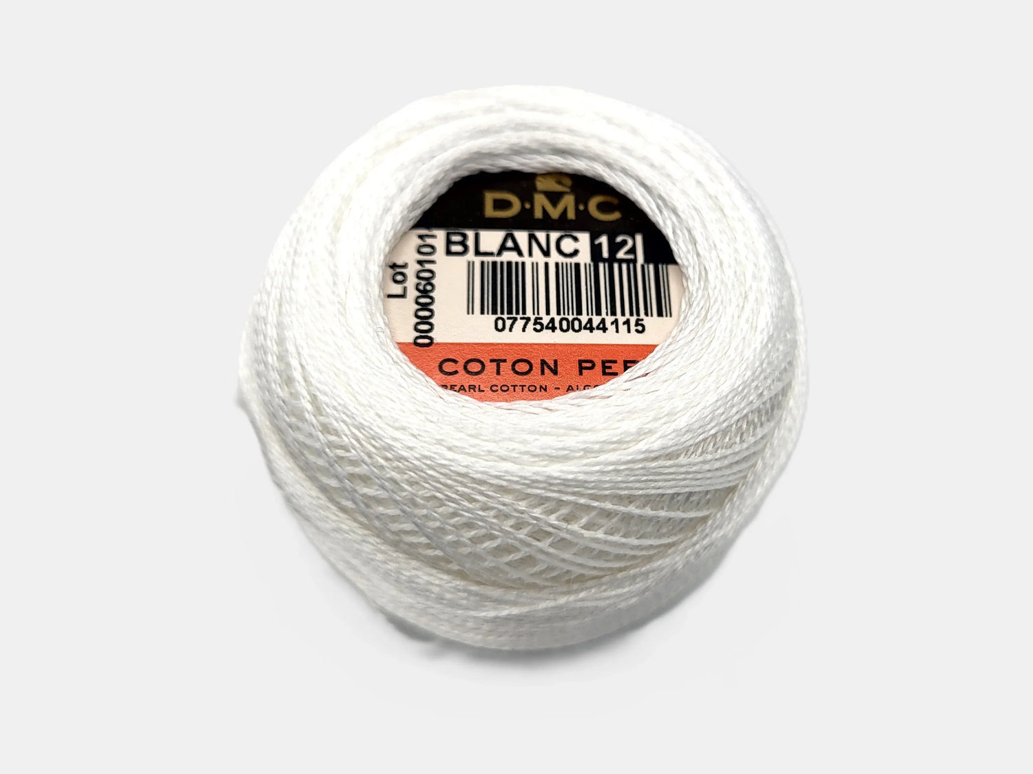 Ball of white thread with a DMC label on a light gray background