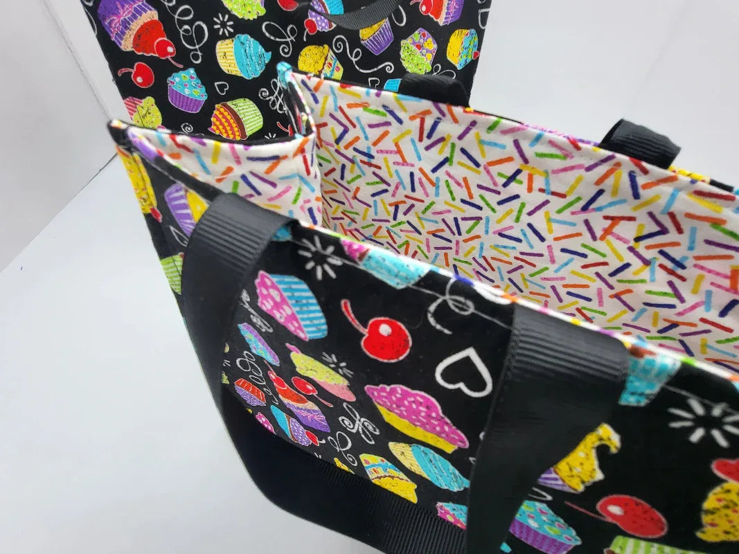 Two fabric bags with colorful designs on a white background
