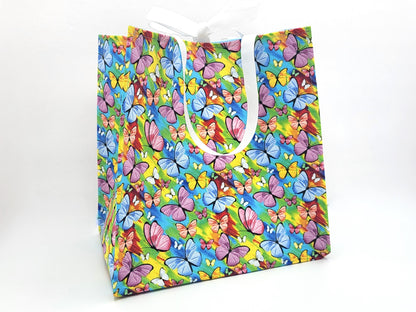 Colorful butterfly-patterned gift bag on a white background