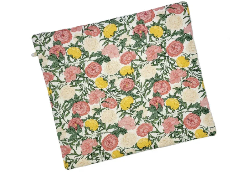 Floral patterned cushion cover with pink, yellow, and green flowers on a white background