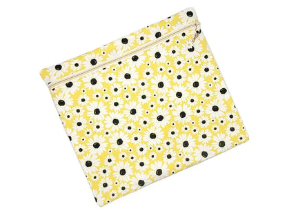 Yellow pouch with black floral pattern on a white background