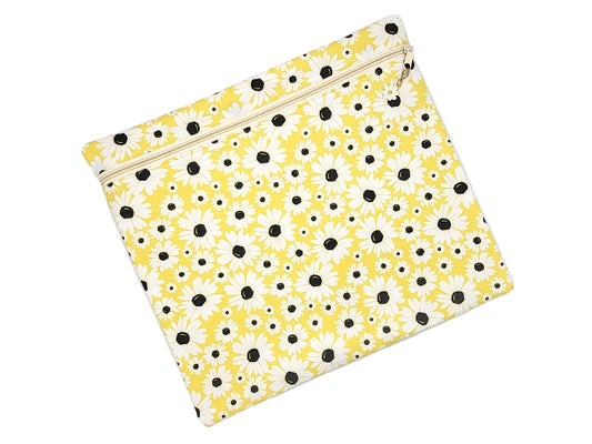 Yellow pouch with black floral pattern on a white background