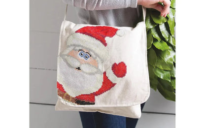 Tote bag with a pixelated design of a character, held by a person.