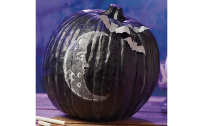 Decorative pumpkin with a moon and star design on a blue background
