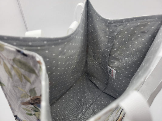 Gray polka dot fabric inside a fabric giftbag with birds