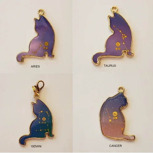 Four cat-shaped zodiac pendants labeled Aries, Taurus, Gemini, and Cancer on a light beige background.