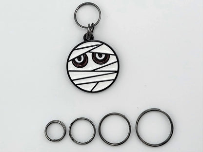 Mummy stitch markers with ring attachments — flat lay sampler of ring sizes
